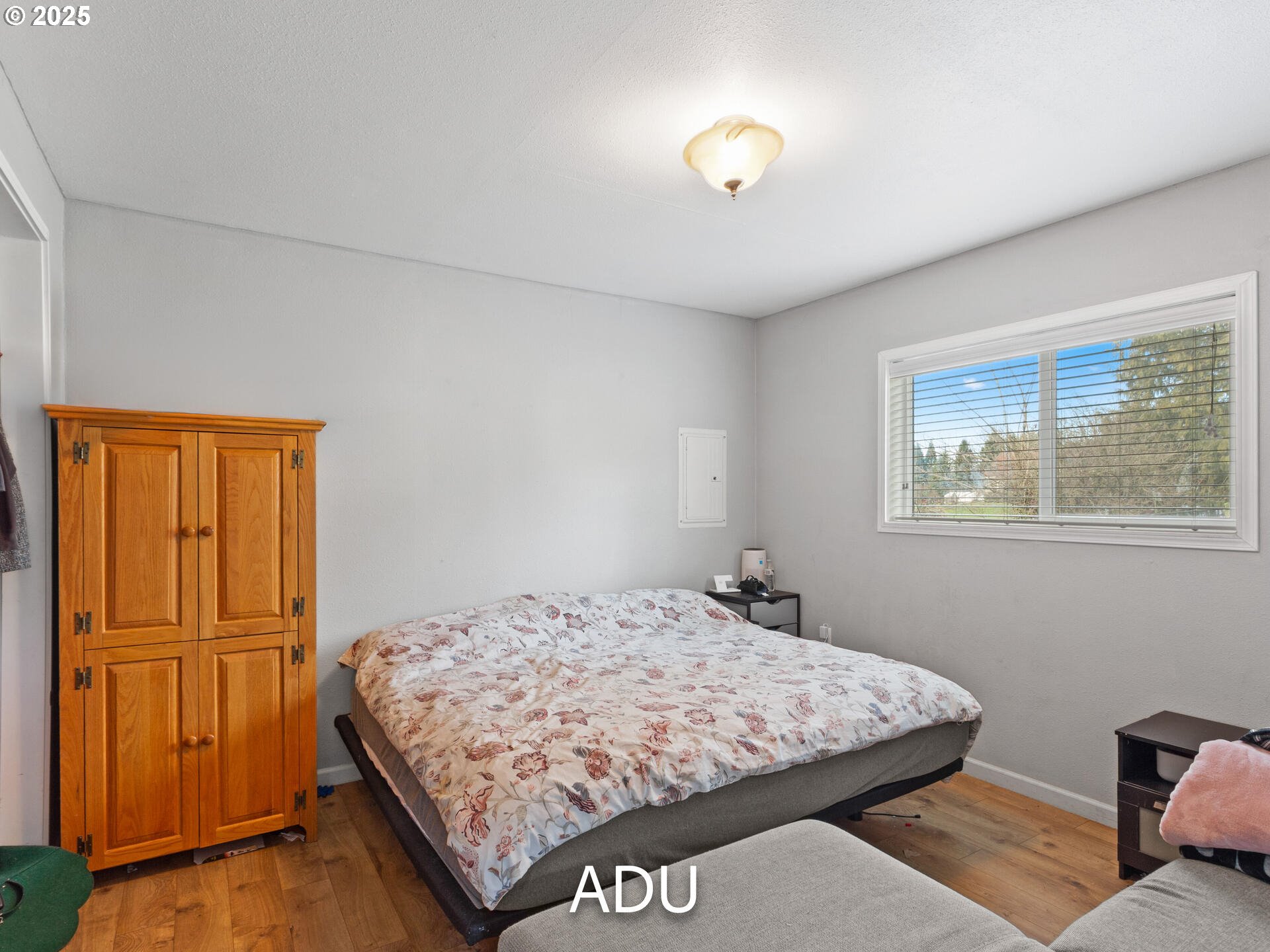 1621 Northeast 194th Street Ridgefield, WA 98642 - Photo 46 of 48 a bedroom with a bed and wooden cabinets