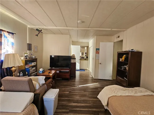 a bedroom with furniture and a flat screen tv