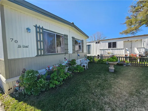 a backyard of a house with barbeque oven table and chairs