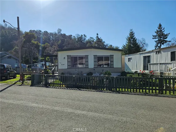 a view of a house with a wooden fence