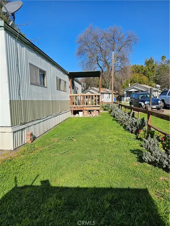 a view of a house with backyard and sitting area