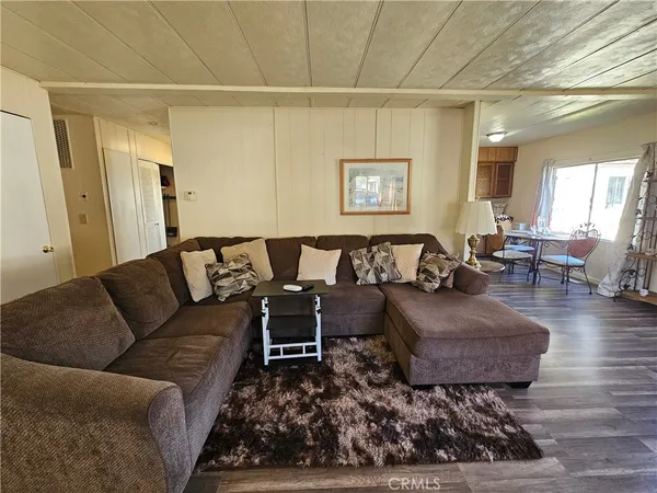 a living room with furniture rug and wooden floor