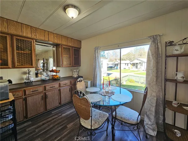 a kitchen with a table chairs sink and cabinets