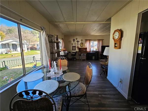 a view of a dining room with furniture large window and wooden floor