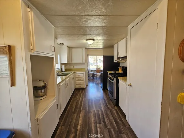 a kitchen with a refrigerator a stove top oven a sink and dishwasher