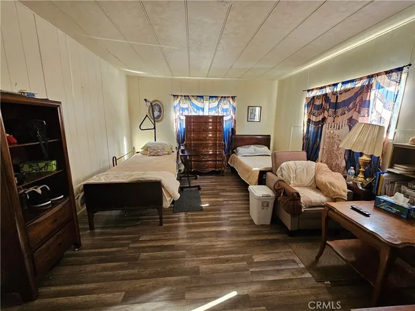 a bedroom with furniture and a flat screen tv