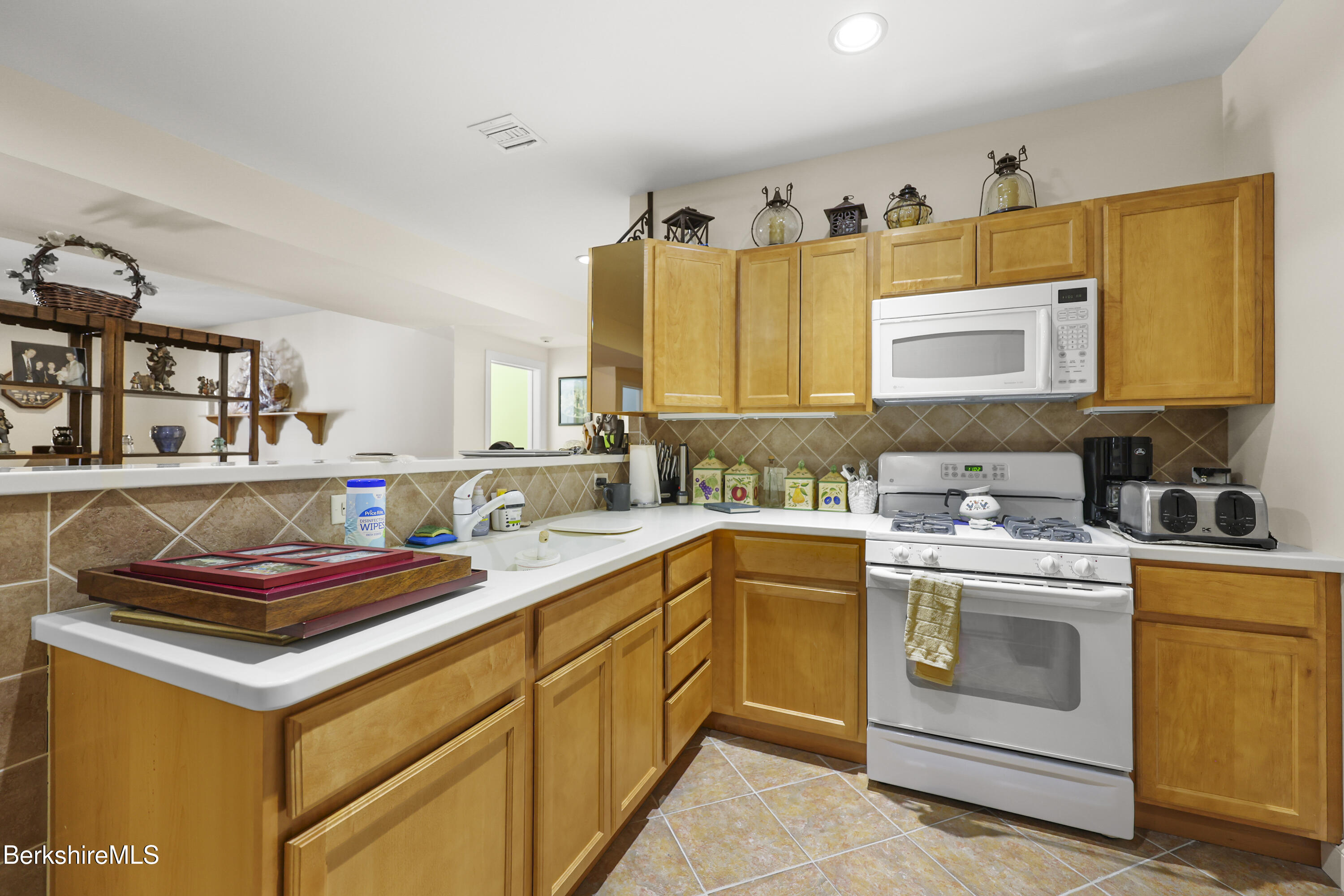 581 Red Barn Road Dalton, MA 01226 - Photo 45 of 65 a kitchen with stainless steel appliances granite countertop a stove a sink and a microwave