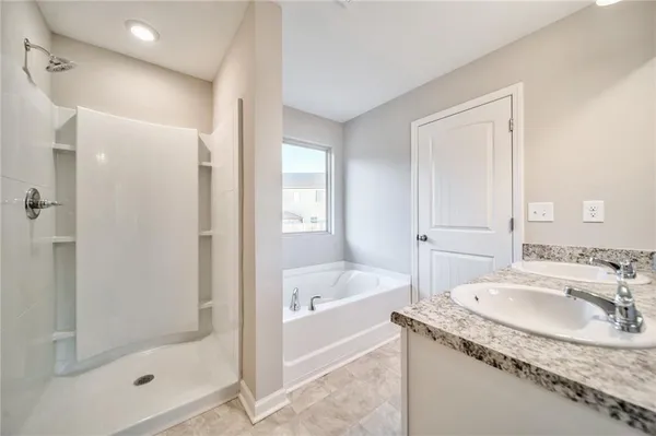 a bathroom with a tub sink and mirror