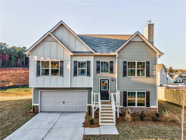 a view of a house with a yard and balcony