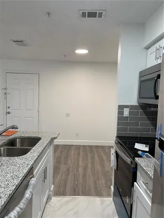 a kitchen that has a sink and a stove