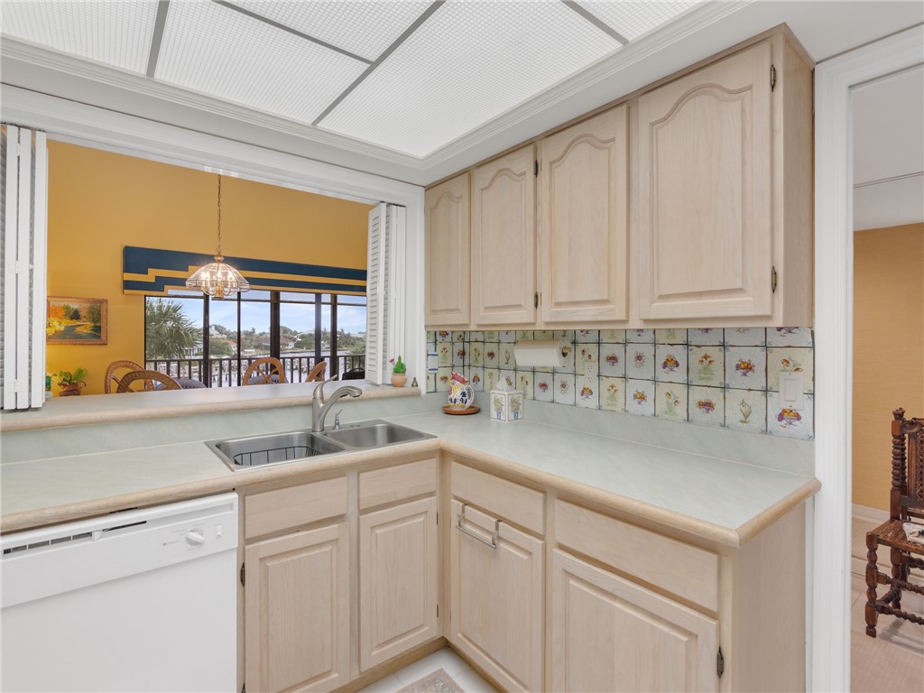 1880 Bay Road, Unit I319 Vero Beach, FL 32963 - Photo 12 of 36 a kitchen with white cabinets and a window