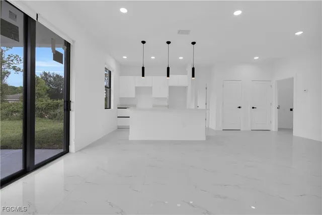 a kitchen with stainless steel appliances granite countertop a sink and a refrigerator