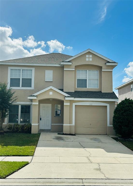 1112 Timberbend Circle Orlando, FL 32824 - Photo 1 of 1 a front view of a house with a yard and garage