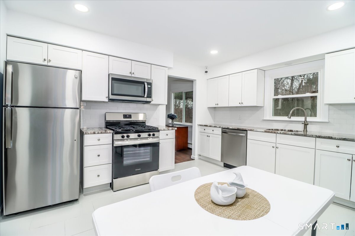 33 Hickory Hill Road Brookfield, CT 06804 - Photo 13 of 35 a kitchen with a stove a sink and a refrigerator