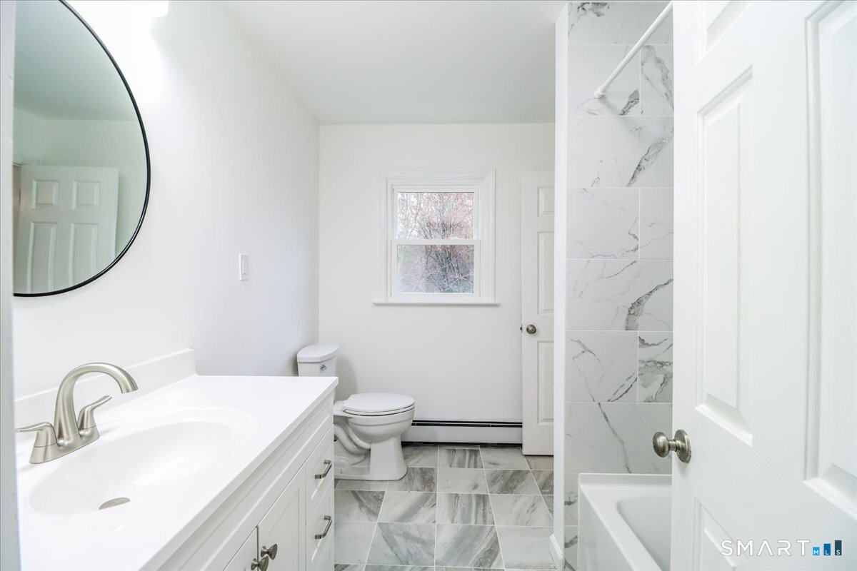 33 Hickory Hill Road Brookfield, CT 06804 - Photo 21 of 35 a bathroom with a sink a toilet and a mirror