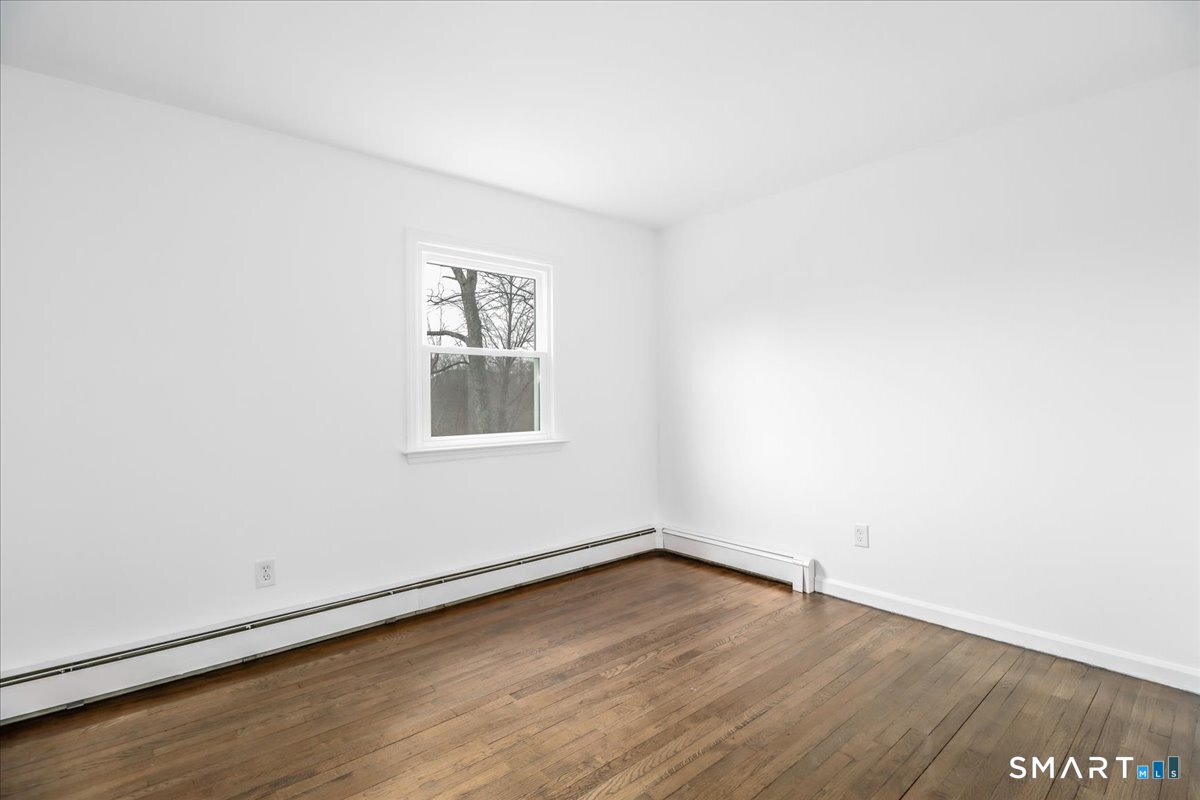 33 Hickory Hill Road Brookfield, CT 06804 - Photo 24 of 35 an empty room with wooden floor and window