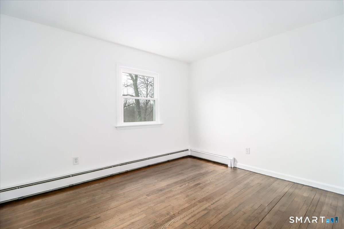 33 Hickory Hill Road Brookfield, CT 06804 - Photo 25 of 35 an empty room with wooden floor and windows