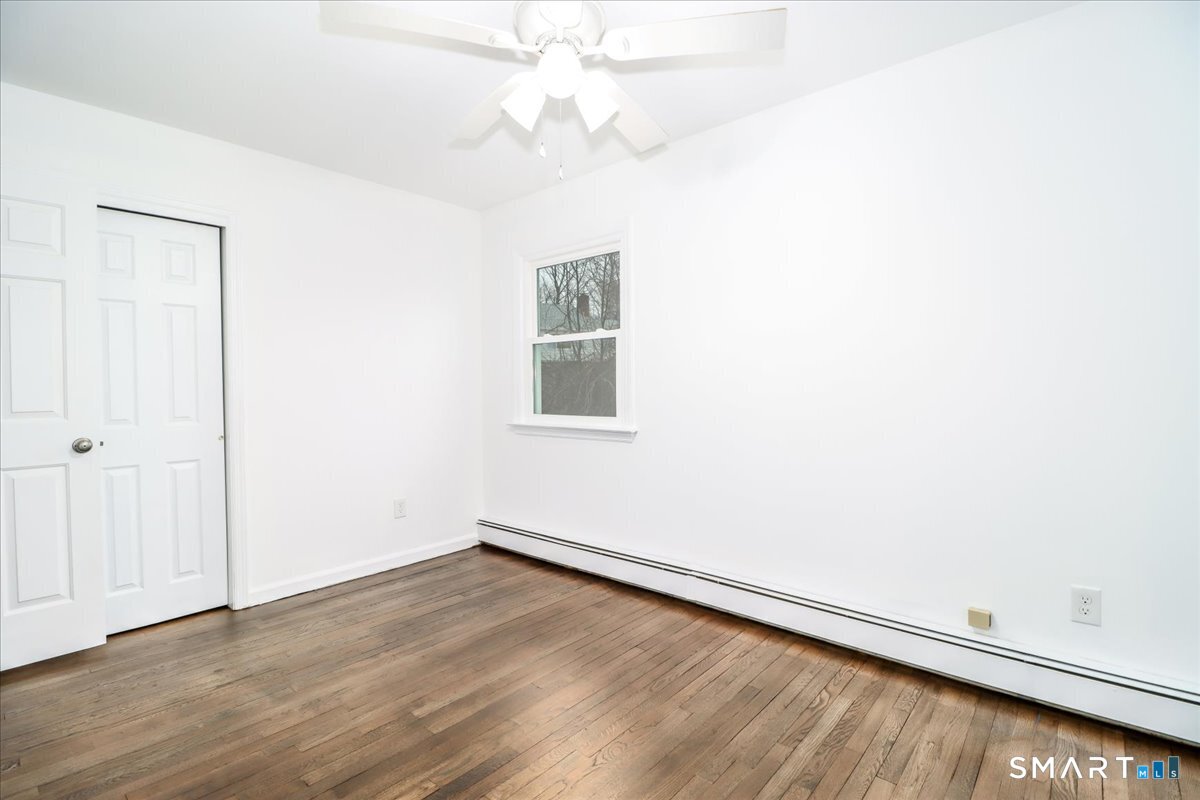 33 Hickory Hill Road Brookfield, CT 06804 - Photo 26 of 35 an empty room with a window and a ceiling fan