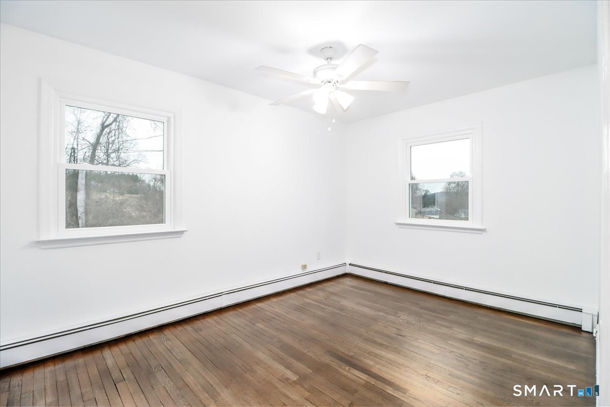 33 Hickory Hill Road Brookfield, CT 06804 - Photo 27 of 35 a view of an empty room with wooden floor and a window