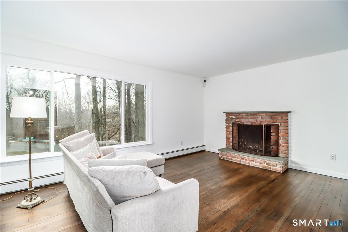 33 Hickory Hill Road Brookfield, CT 06804 - Photo 6 of 35 a living room with furniture and a fireplace