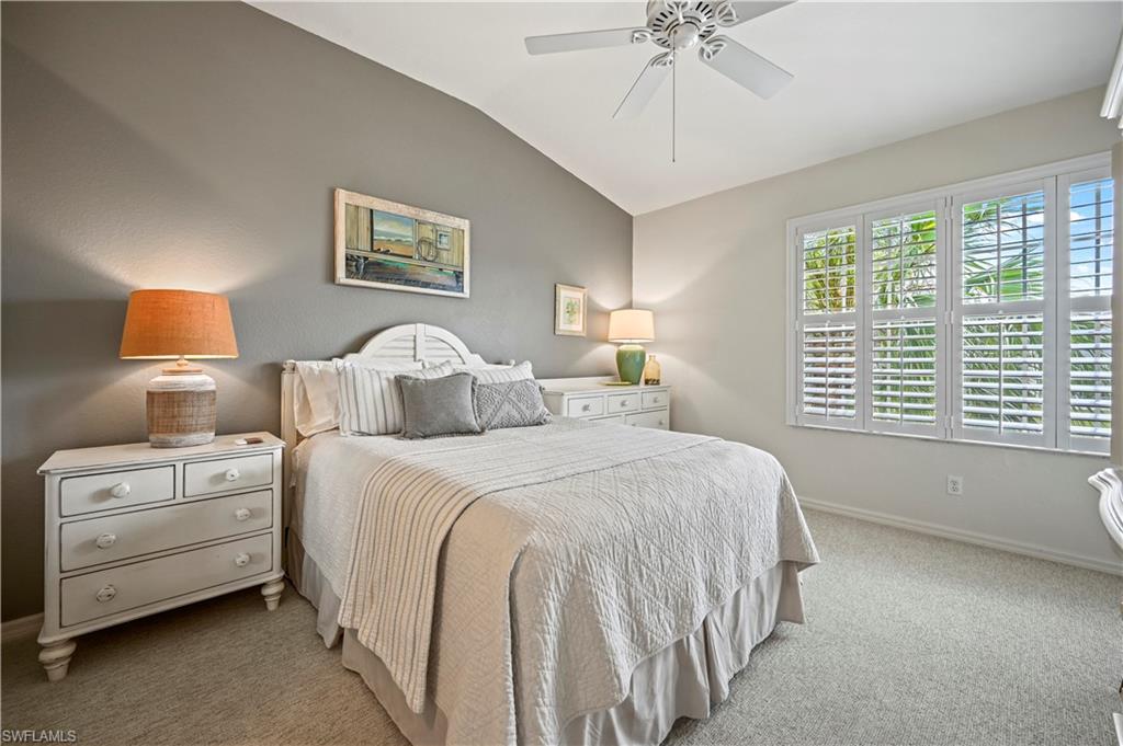 23810 Marbella Bay Road, Unit 203 Estero, FL 34135 - Photo 13 of 47 Bedroom with carpet flooring, ceiling fan, and vaulted ceiling