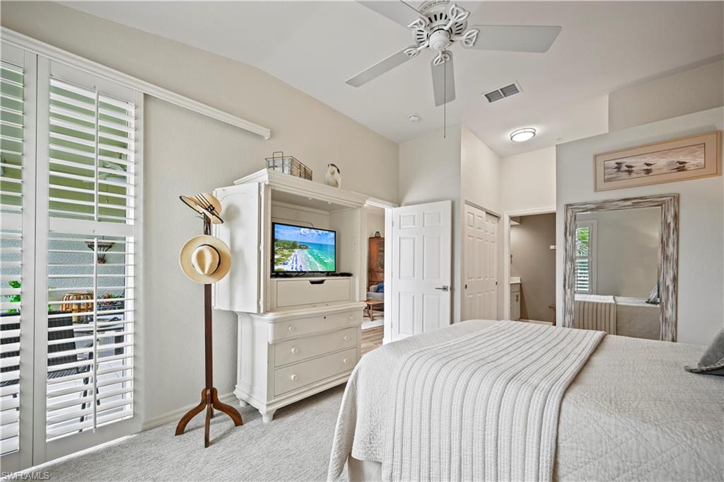 23810 Marbella Bay Road, Unit 203 Estero, FL 34135 - Photo 14 of 47 Bedroom featuring carpet floors, ceiling fan, vaulted ceiling, and a closet