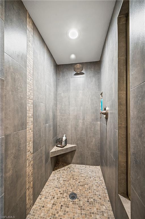 23810 Marbella Bay Road, Unit 203 Estero, FL 34135 - Photo 16 of 47 Bathroom featuring a tile shower