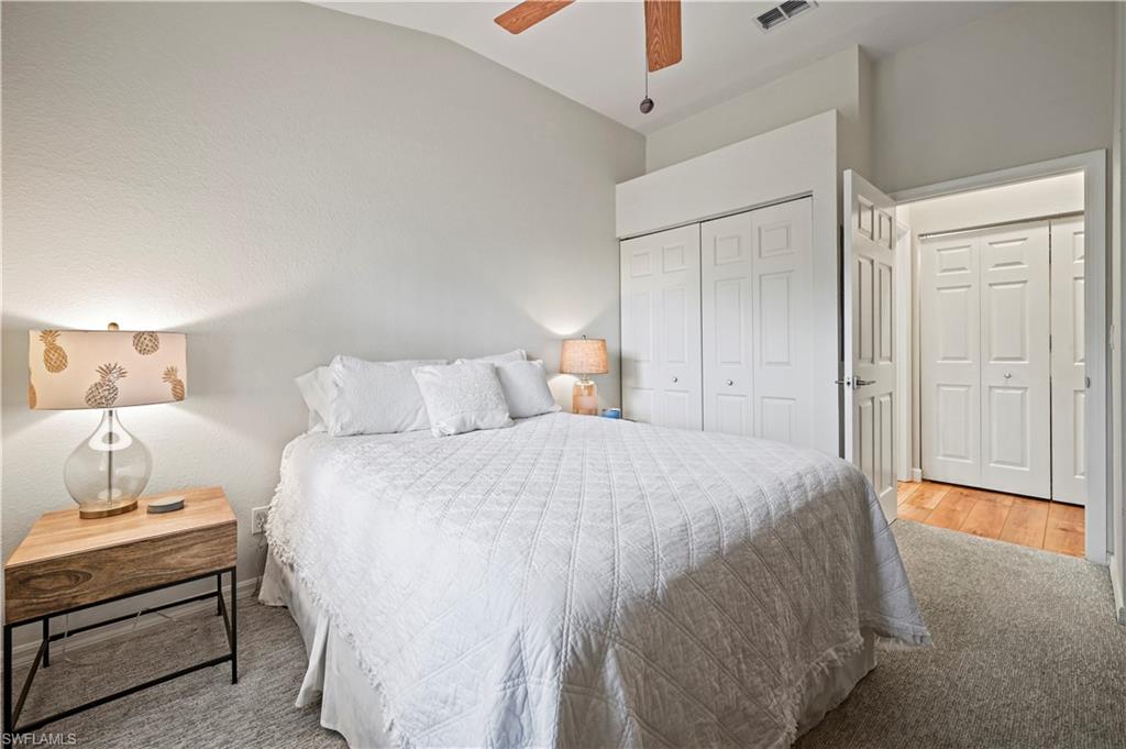 23810 Marbella Bay Road, Unit 203 Estero, FL 34135 - Photo 18 of 47 Bedroom featuring ceiling fan, vaulted ceiling, and light hardwood / wood-style flooring