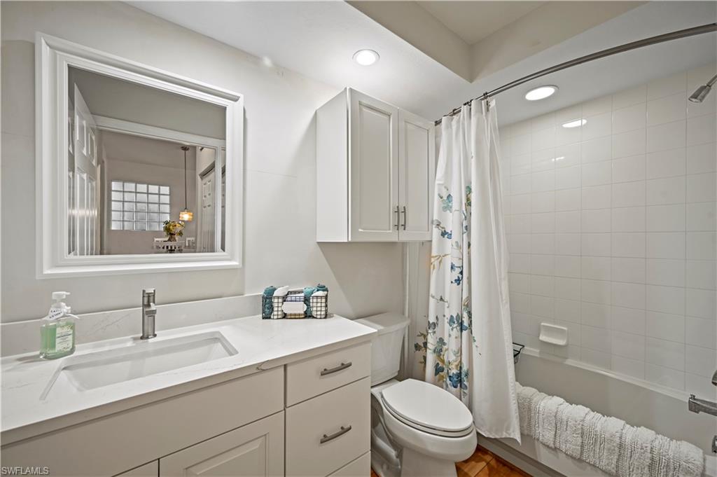 23810 Marbella Bay Road, Unit 203 Estero, FL 34135 - Photo 19 of 47 Full bathroom featuring shower / bath combo, toilet, and vanity