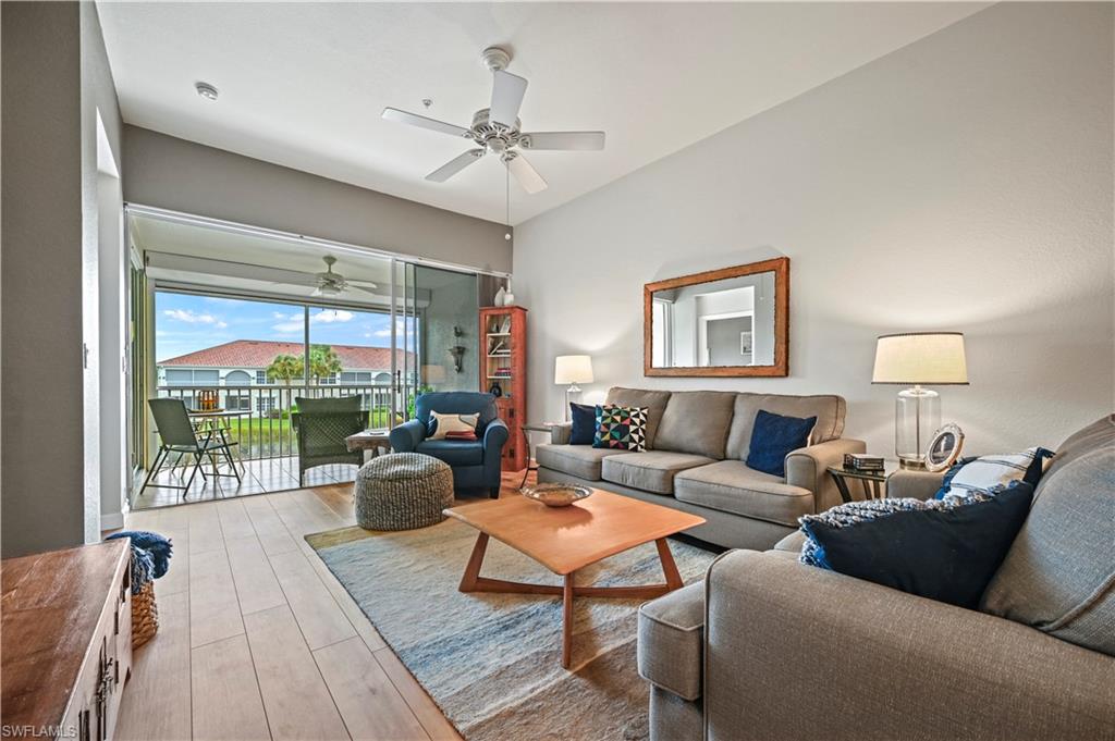 23810 Marbella Bay Road, Unit 203 Estero, FL 34135 - Photo 8 of 47 Living room featuring ceiling fan and light wood-type flooring