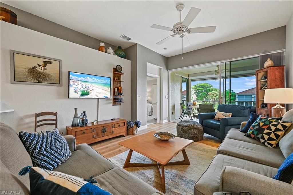 23810 Marbella Bay Road, Unit 203 Estero, FL 34135 - Photo 9 of 47 Living room featuring light wood-type flooring and ceiling fan