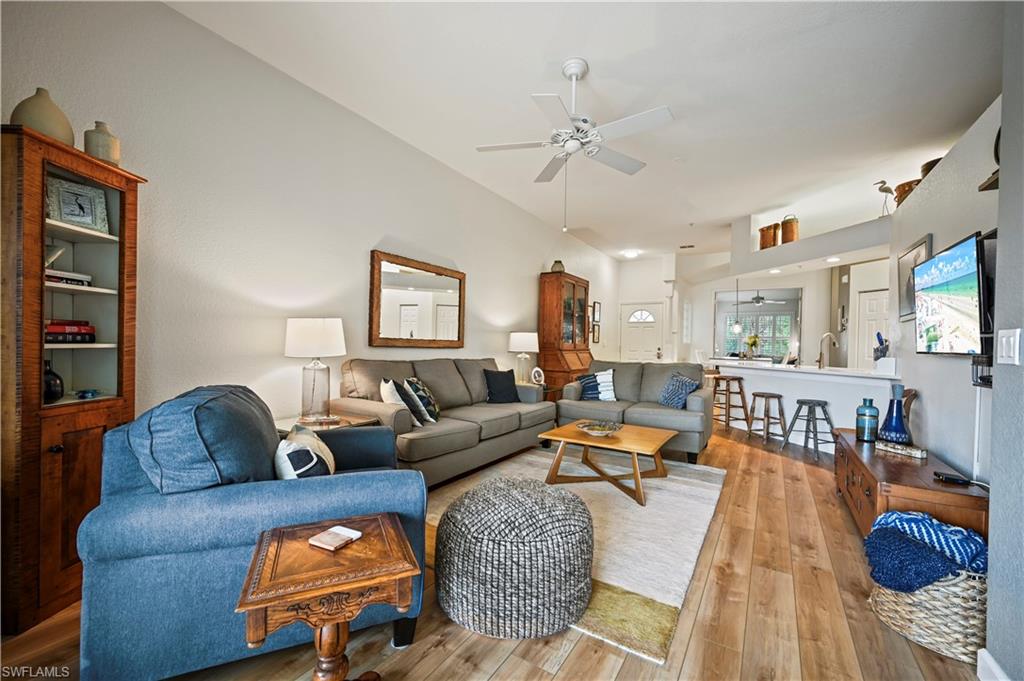 23810 Marbella Bay Road, Unit 203 Estero, FL 34135 - Photo 10 of 47 Living room featuring ceiling fan and light wood-type flooring