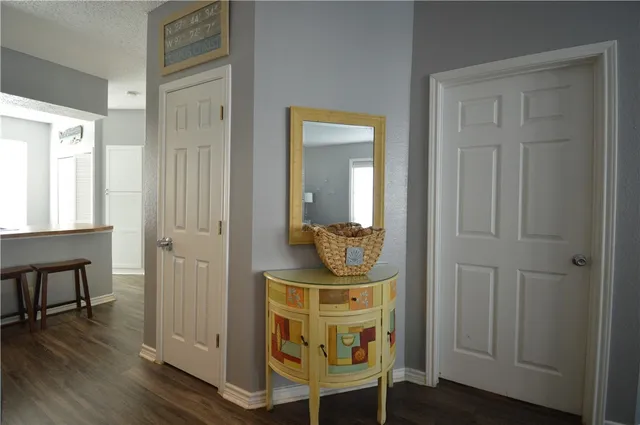 a kitchen with a sink and a stove with wooden floor