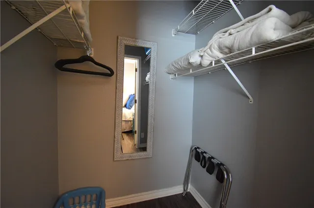 a bedroom with two bed and a window