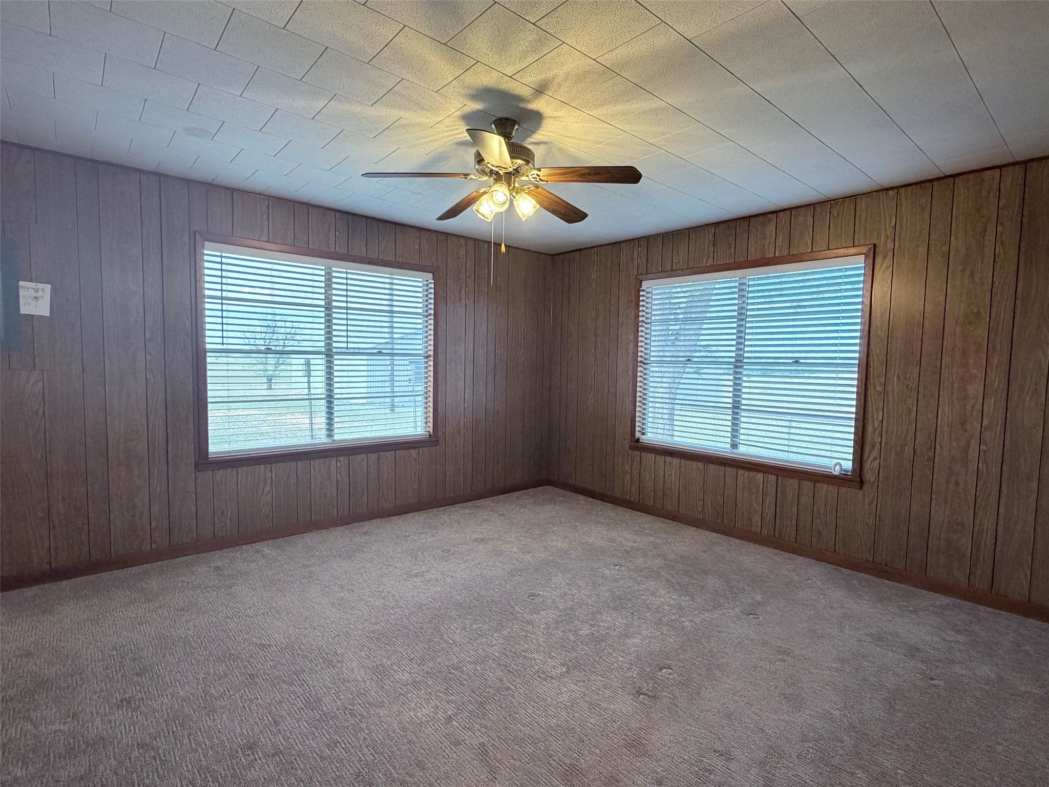 500 Greasy Bend Road Smithville, TX 78957 - Photo 14 of 21 an empty room with windows and fan