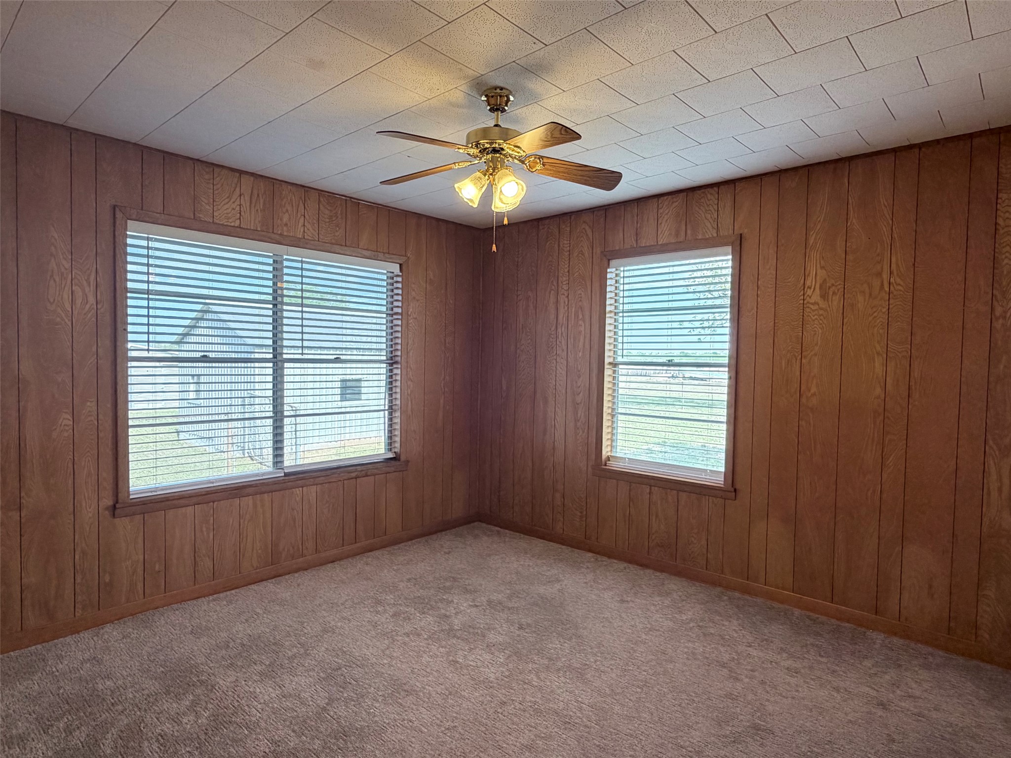 500 Greasy Bend Road Smithville, TX 78957 - Photo 10 of 21 an empty room with windows and chandelier fan