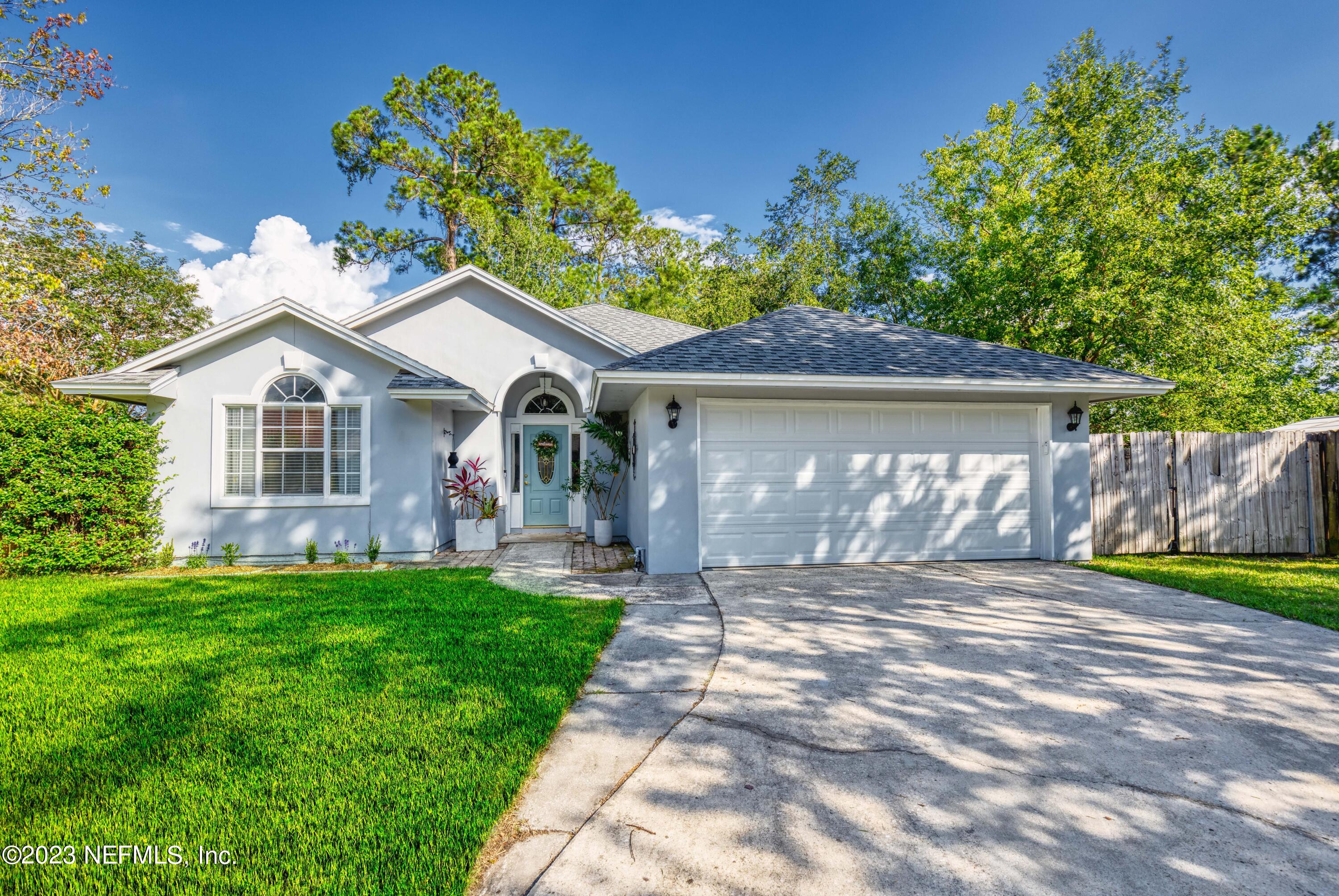 a front view of a house with a garden and yard