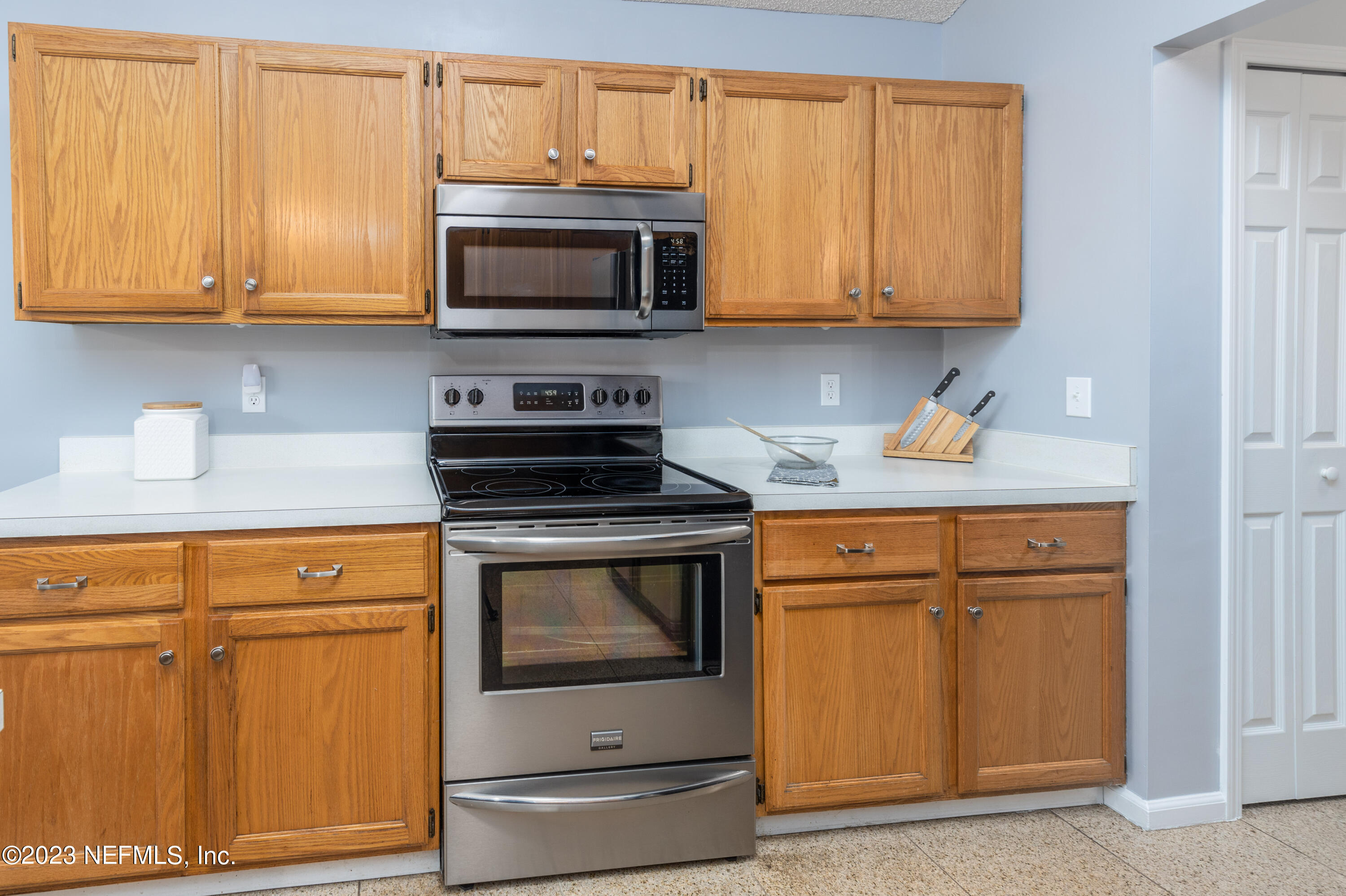 9698 Pritmore Road East Jacksonville, FL 32257 - Photo 10 of 28 a kitchen with stainless steel appliances granite countertop a stove microwave and sink