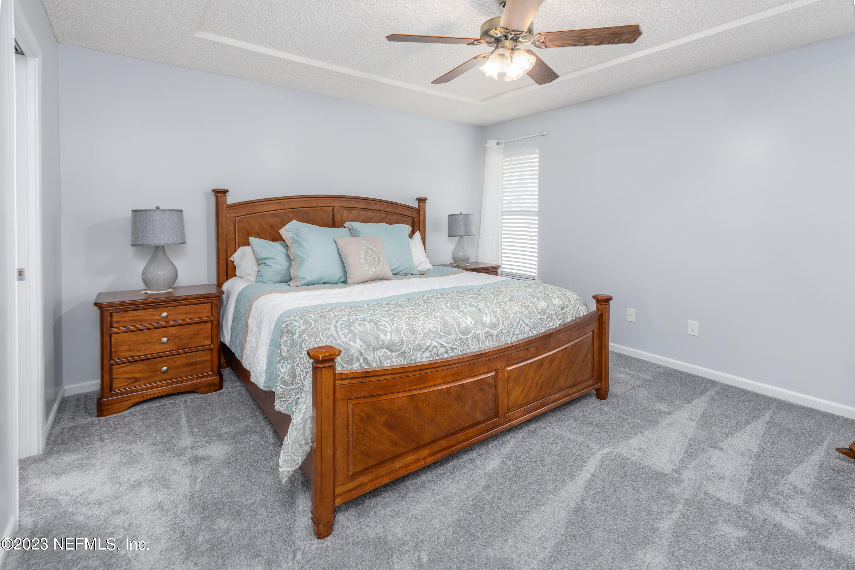 9698 Pritmore Road East Jacksonville, FL 32257 - Photo 11 of 28 a bed sitting in a room next to a lamp