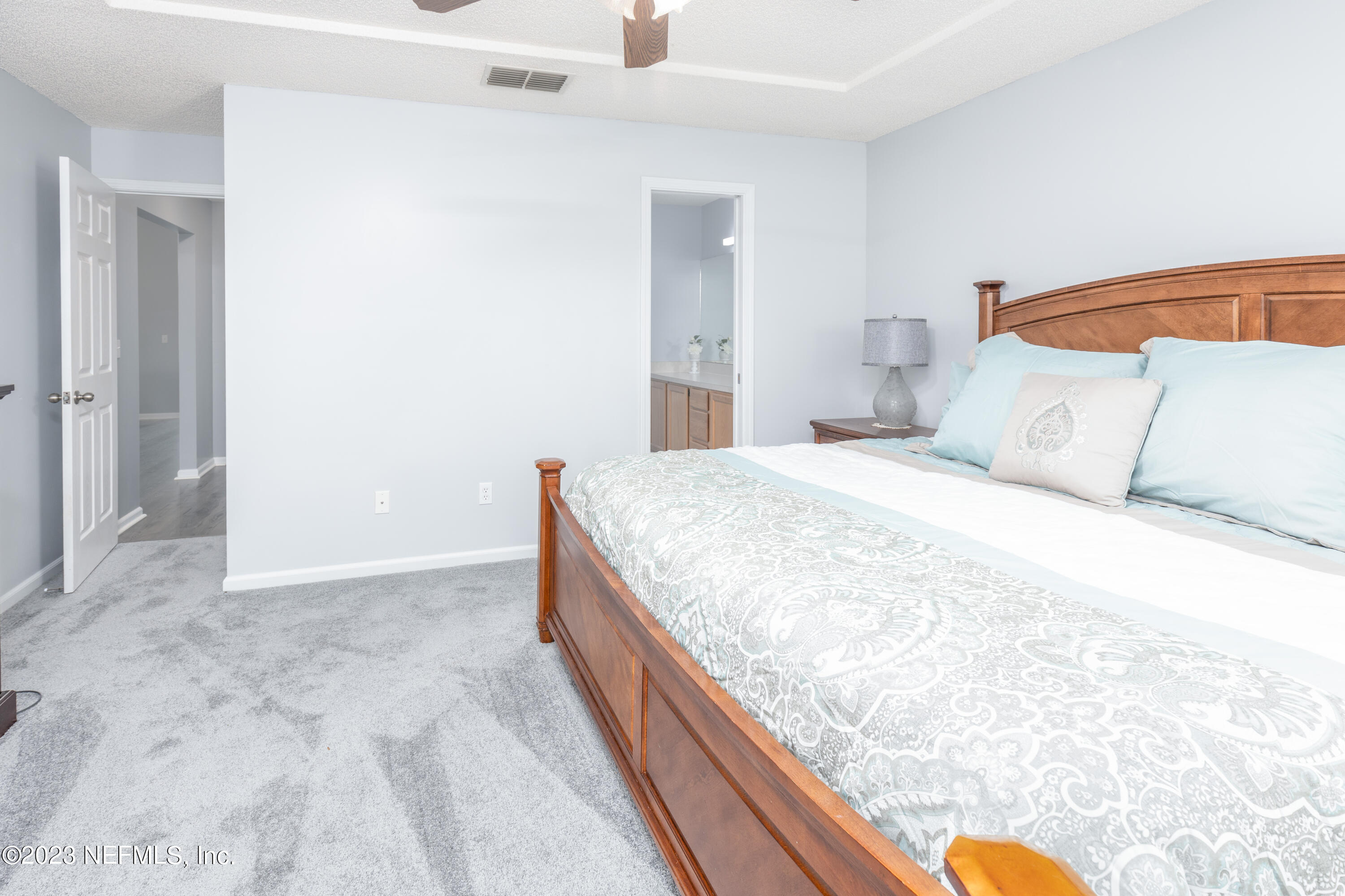 9698 Pritmore Road East Jacksonville, FL 32257 - Photo 12 of 28 a bedroom with a bed and blue wall