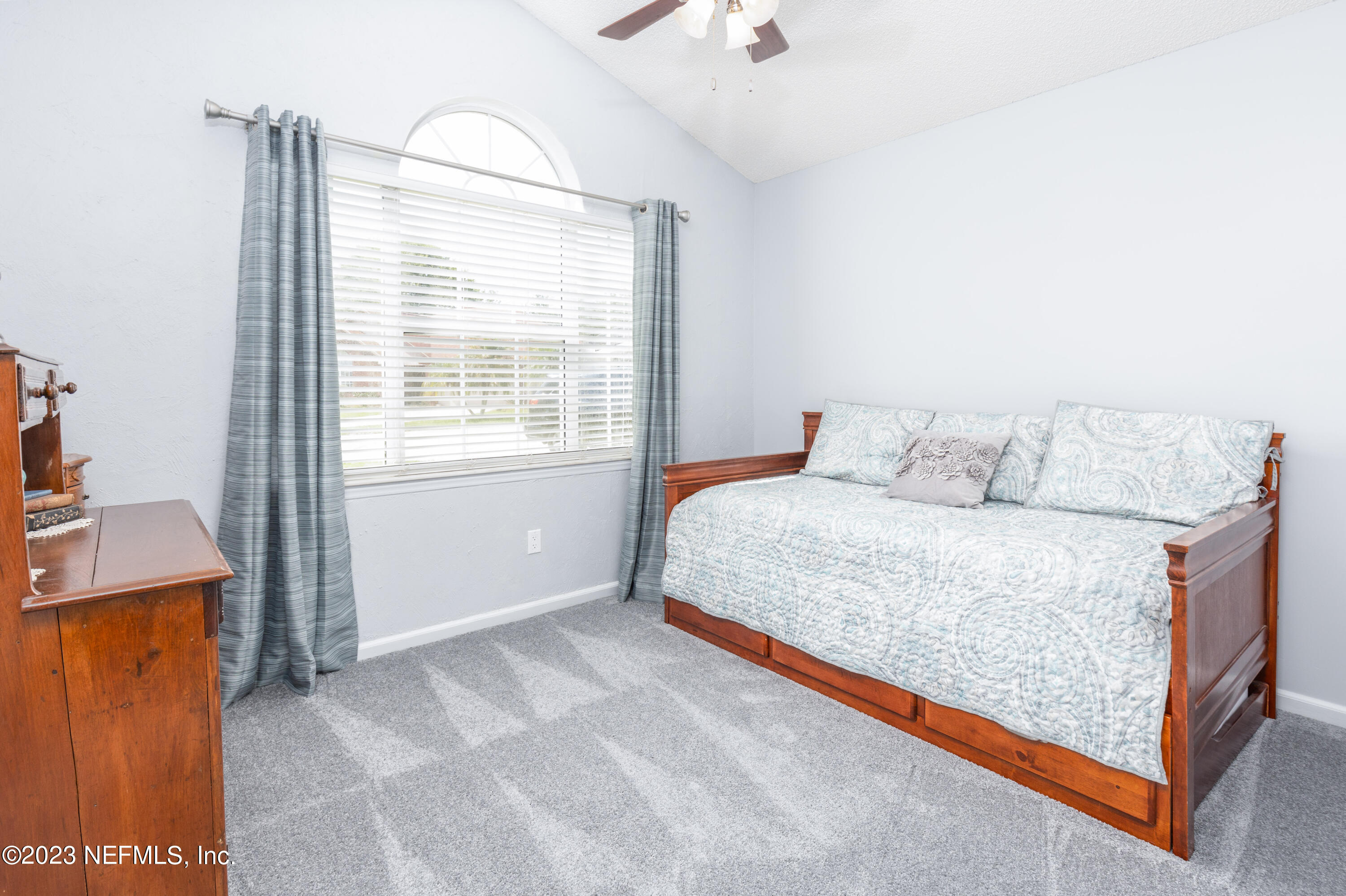 9698 Pritmore Road East Jacksonville, FL 32257 - Photo 15 of 28 a bedroom with a bed and window