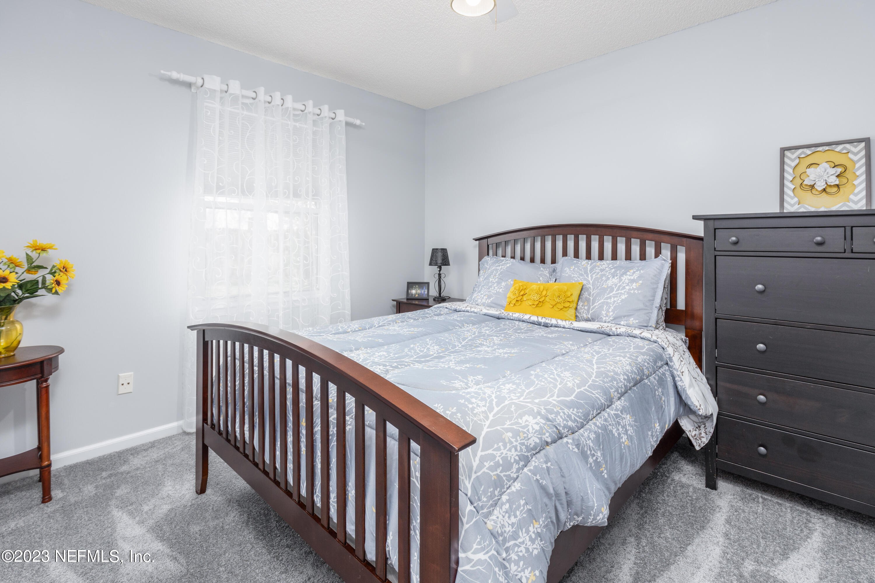 9698 Pritmore Road East Jacksonville, FL 32257 - Photo 18 of 28 a bedroom with a bed and painting on the wall