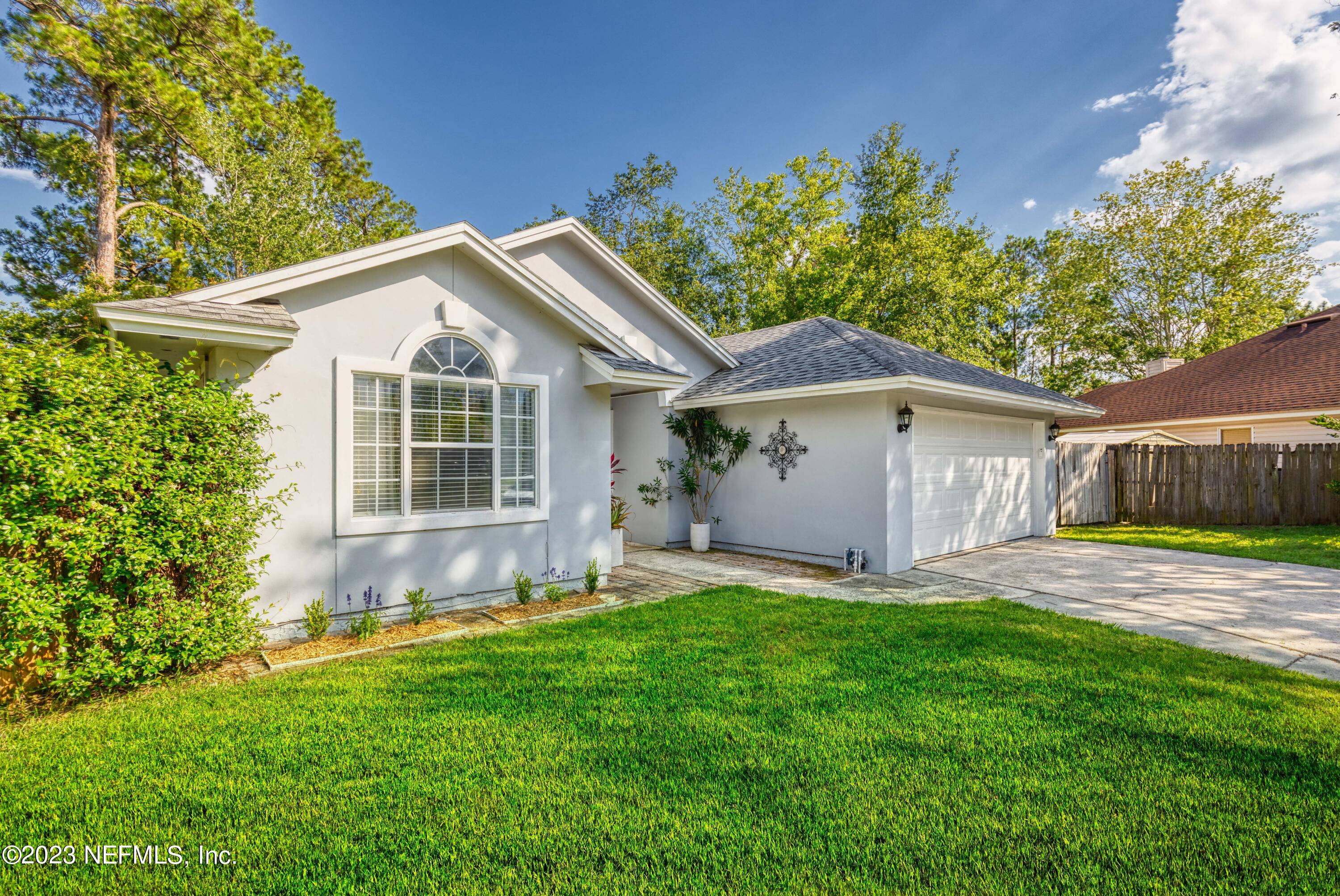 9698 Pritmore Road East Jacksonville, FL 32257 - Photo 2 of 28 a front view of a house with a yard and garage