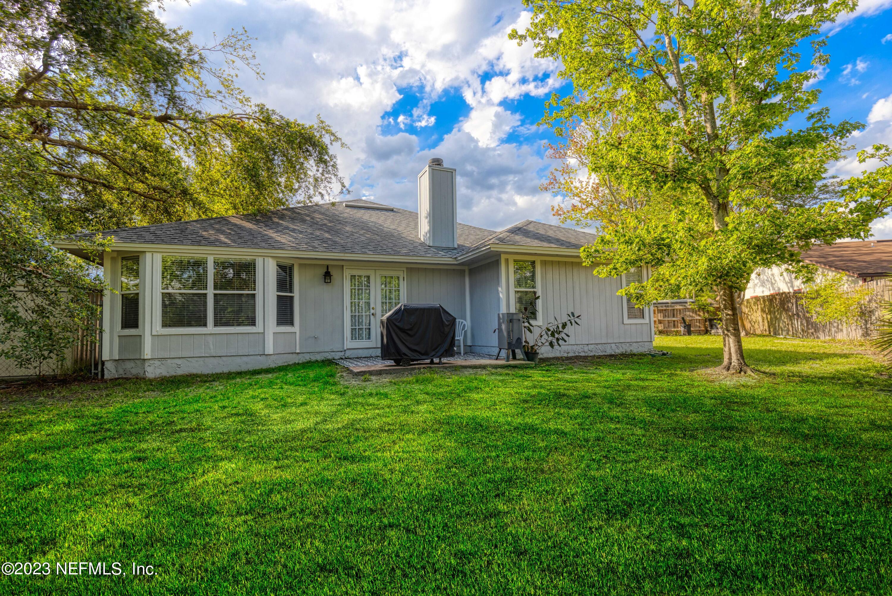9698 Pritmore Road East Jacksonville, FL 32257 - Photo 21 of 28 a front view of a house with garden
