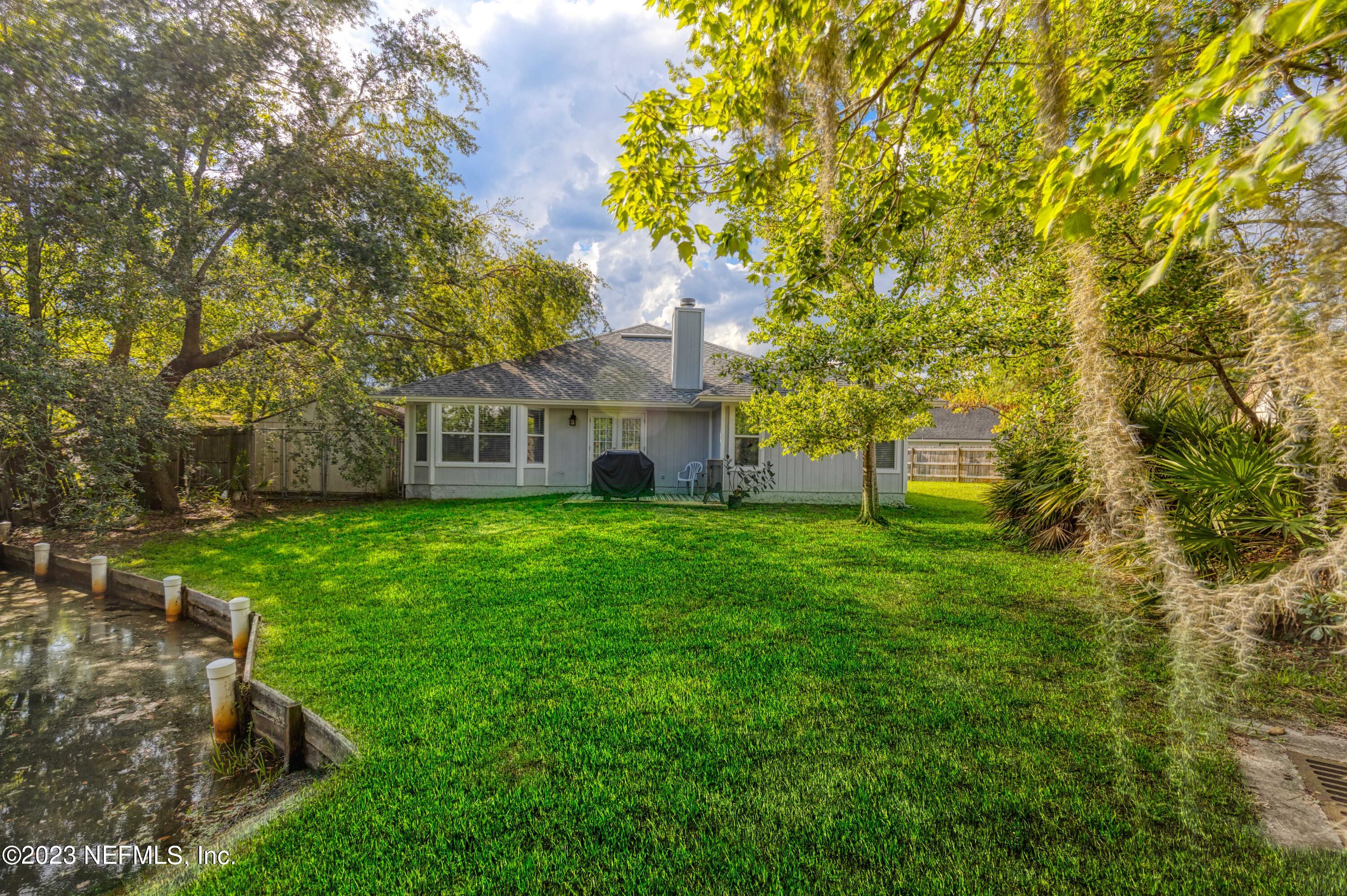 9698 Pritmore Road East Jacksonville, FL 32257 - Photo 22 of 28 a view of a house with a yard