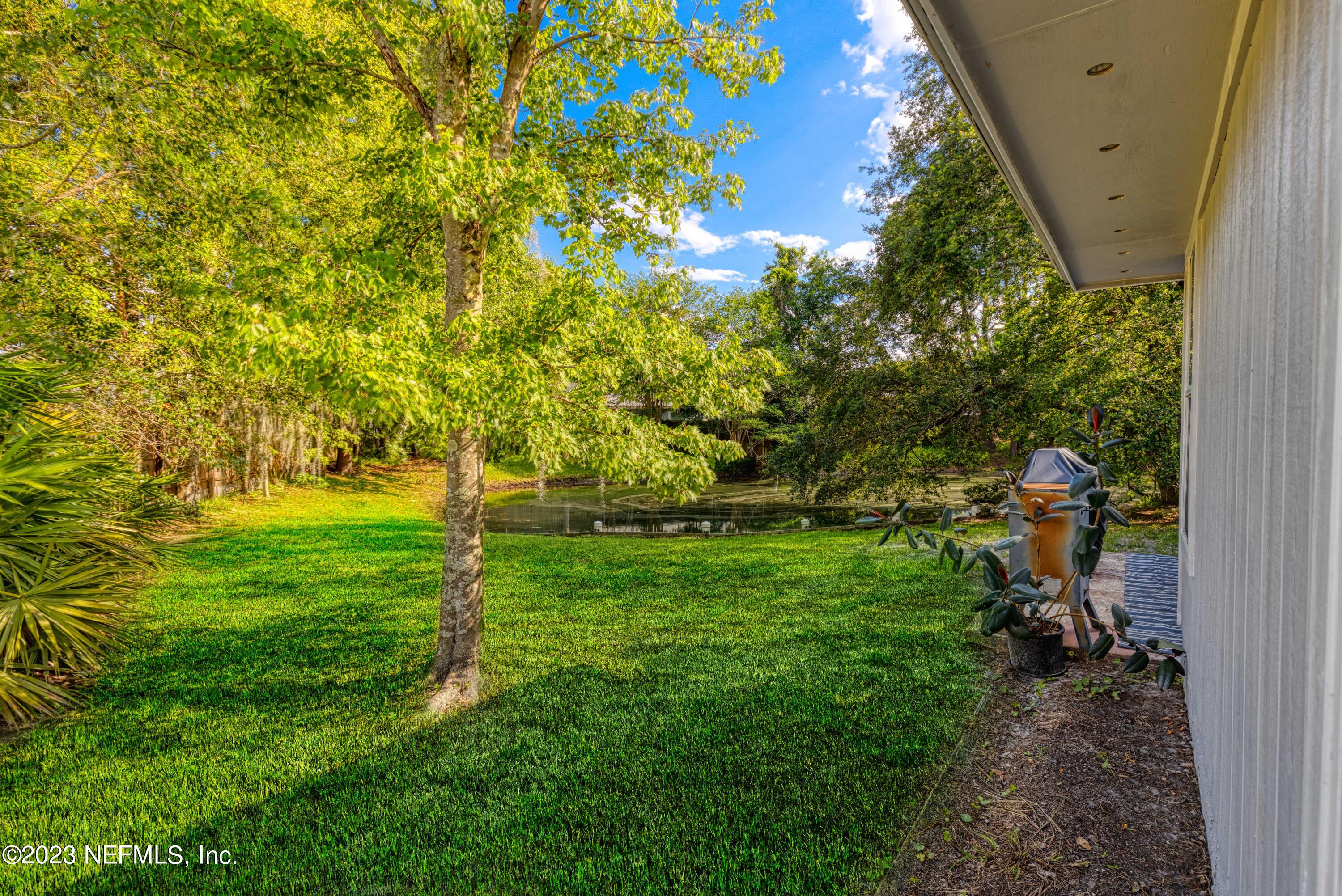 9698 Pritmore Road East Jacksonville, FL 32257 - Photo 26 of 28 a backyard of a house with lots of green space