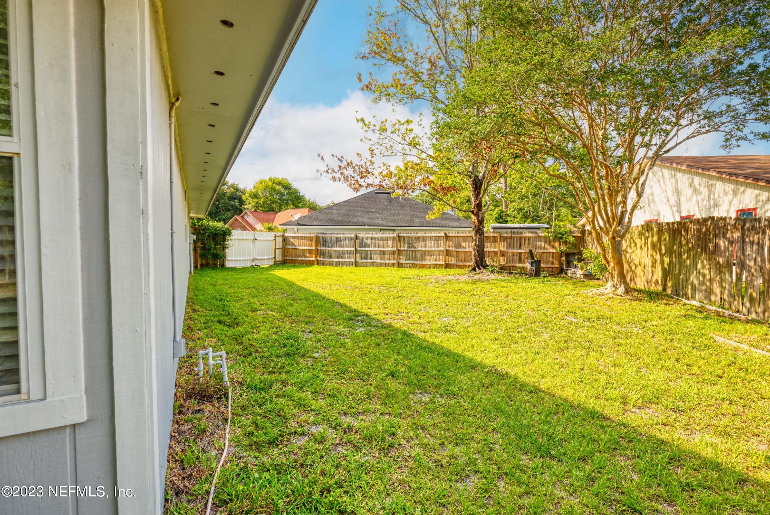 9698 Pritmore Road East Jacksonville, FL 32257 - Photo 27 of 28 a view of a swimming pool with an outdoor space and seating area