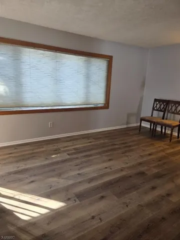 a view of a room with wooden floor and chair