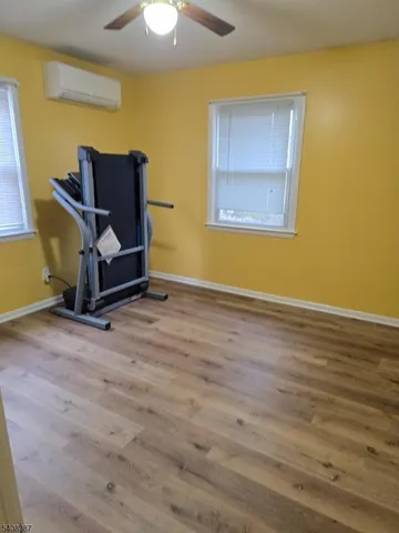 a room with wooden floor and furniture