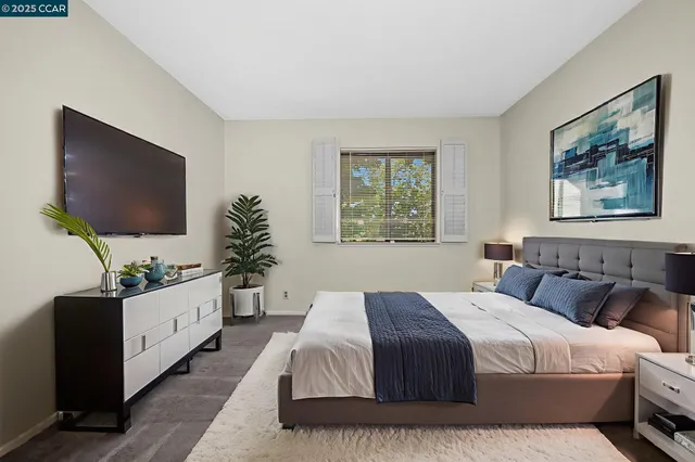 a spacious bedroom with a large bed and a flat screen tv